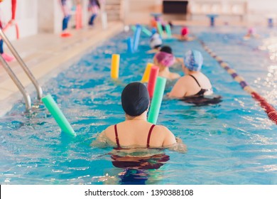 women trains in aqua aerobics, learn to swim.
