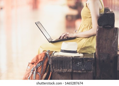 Women Traveler Are Watching The Map,use Computer, Waiting For Someone, Or Taxi In The Train Station.