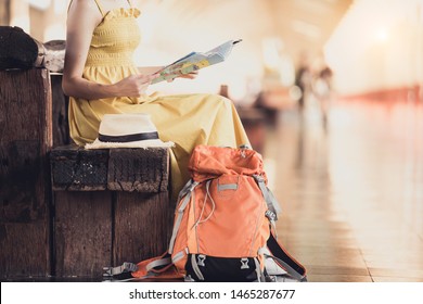 Women Traveler Are Watching The Map,use Computer, Waiting For Someone, Or Taxi In The Train Station.