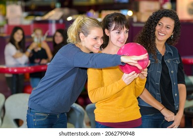 women trying to play bowling