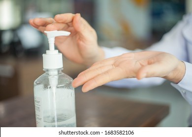 Women using alcohol gel for cleaning hands