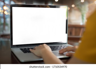 Women Using Laptop Computer Working At Home With Blank White Desktop Screen.