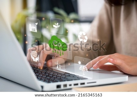 women using laptop for working technology and business Net zero and carbon neutral concept. Renewable energy-based green businesses can limit climate change and global warming. 
Reduce CO2 emission.