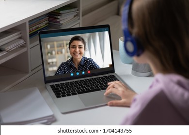 Women via videocall talking using webcam pc internet connection, view over girl shoulder. Indian ethnicity teacher share knowledge with learner. Video Conference application, modern tech usage concept