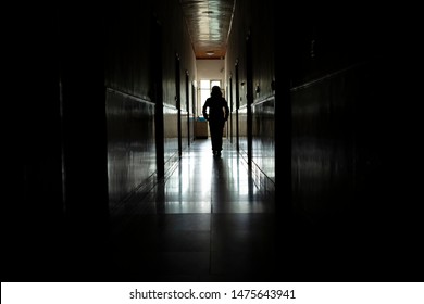 Women are walking alone in the dark.Light at the end of the tunnel concept. - Powered by Shutterstock