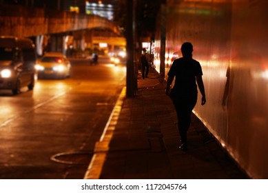 Women Walking Alone On Foot Path In The Night.