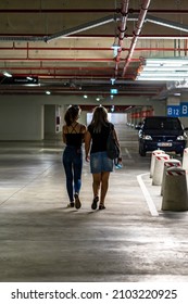 Women Walking Alone In Underground Parking Garage In Bucharest, Romania, 2021