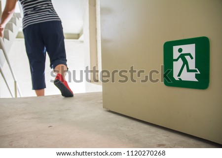 women walking to the emergency fire exit door