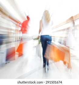 Women Walking Fast In Shopping Mall With Bags