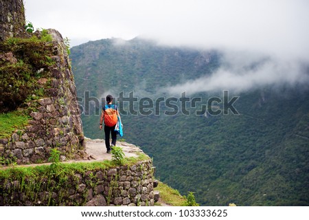 Women walking on the edge of a cliff, Machu Picchu, Peru