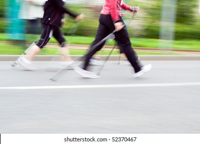 Women Walking On Nordic Walking Race In City