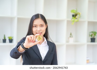 Women Ware Black Suit Showing Bitcoin Coin In Office