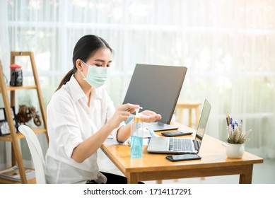 Women Washing Hands With Alcohol Gel Before Returning To Work At Home.