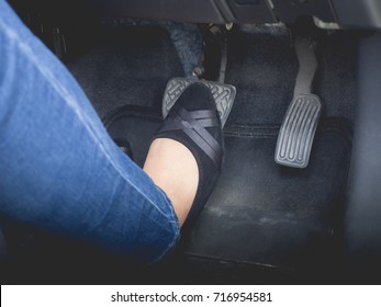 Women Wear Casual Shoes Use Foot Right Brake Pedal Of Car.