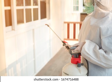 Women wear personal protective suit or PPE, goggle and mask making disinfection and decontamination on a public place or house to reduce spreading of disease during covid-19 outbreak. Medical concept. - Shutterstock ID 1674716488
