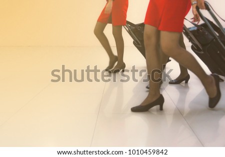 Women wear short skirts Wear high heels Luggage with blur lens and flare light