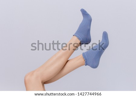 Women wearing blue socks Gray background