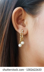 Women wearing earrings - Shutterstock ID 1302622633