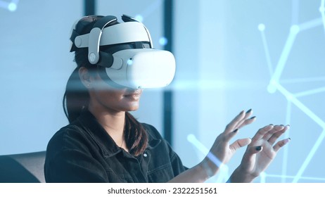 Women wearing VR goggles posing finger pointing and touching on the air connecting to internet metaverse system with holographic screen. Digital technology of the future. Virtual reality concept - Powered by Shutterstock