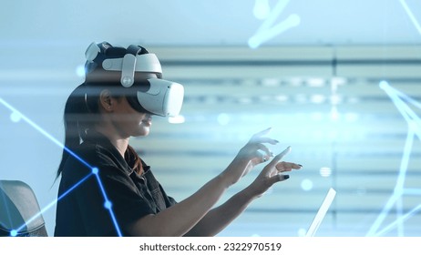 Women wearing VR goggles posing finger pointing and touching on the air connecting to internet metaverse system with holographic screen. Digital technology of the future. Virtual reality concept - Powered by Shutterstock