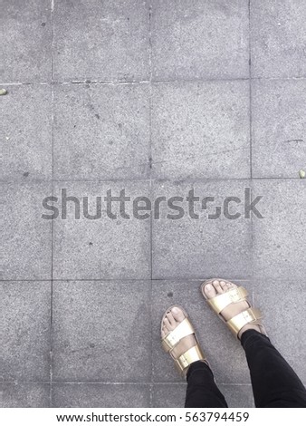 Women wears fashion gold sandal stand on the floor