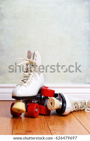 women white roller skates on wood floor