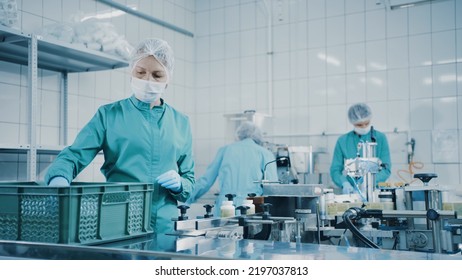 Women Work On The Capsule Packaging Line And Put The Finished Product Into A Box. Bottles On A Conveyor Belt. Production Line Of Pharmaceutical Manufacturing. Pharmaceutical Industry