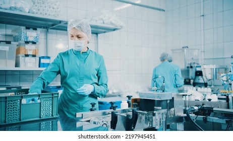 Women Work On The Capsule Packaging Line And Put The Finished Product Into A Box. Bottles On A Conveyor Belt. Production Line Of Pharmaceutical Manufacturing. Pharmaceutical Industry