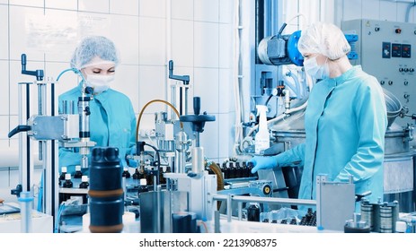 Women Work On The Packaging Line. Preparing Bottles For Use. Female Health Worker. Bottles On A Conveyor Belt. Production Line Of Pharmaceutical Manufacturing. Close Up, DOF