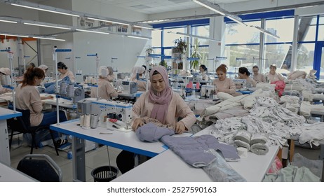 Women work in a sewing workshop. Media. Working process at a textile factory. - Powered by Shutterstock