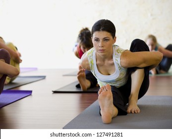 Women At Yoga Class Stretching