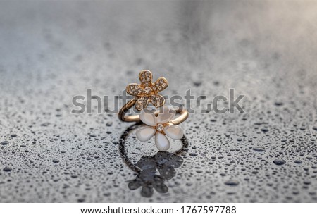 Women's accessories on a glass surface with water droplets