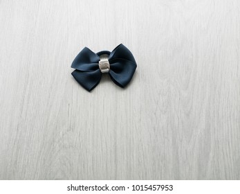 Women's accessories: a rubber band for hair on a gray wooden background. Top view. Copy space.