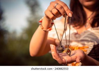 Women's Amulet In Her Hands