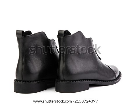 Women's autumn black leather jodhpur boots isolated on white background. Back side view. Fashion shoes. Photoshoot for shoe shop concept.