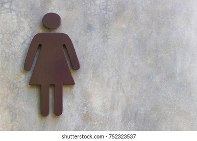 Women's Bathroom Icon Sign (Restroom Or Toilet Room) On The Cement Wall