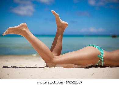 Women's Beautiful Legs On The Beach