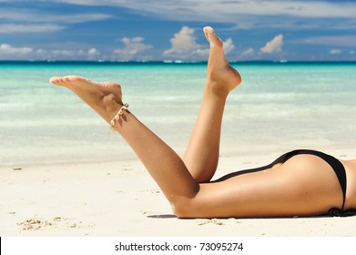 Women's Beautiful Legs On The Beach