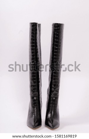 Womens black boots, isolated on white background.