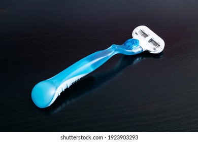 Womens Blue Razor On A Wooden Background Close Up