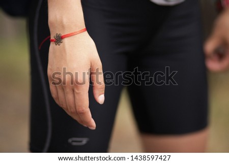 women's bracelet on hand, red thread, ward