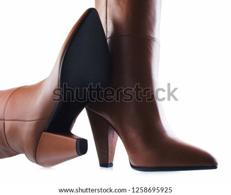 Women's brown leather boots isolated on white background