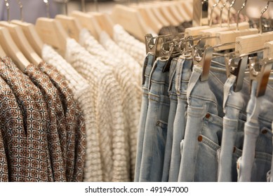 Womens Clothes And Jeans Are Hanging On Hangers In A Store