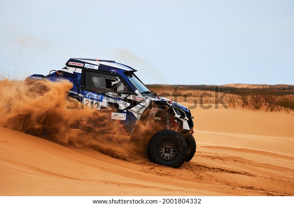 Women\'s crew at the rally. Sports car\
gets over the difficult part of the route during the Rally raid THE\
GOLD OF KAGAN-2021. 26.04.2021 Astrakhan,\
Russia