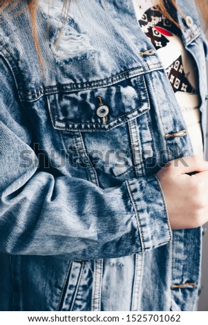 Similar – Frau mit Jeansjacke, blauer Bluse und silberner Armbanduhr.