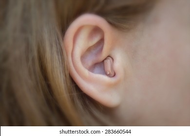 Women's Ear With A Hearing Aid
