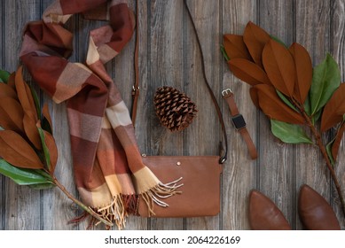 Women's Fall Accessories In Cognac Leather On Rustic Wood Background