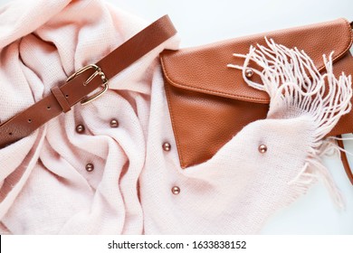 Women's fashion and style. women's accessories. warm pink scarf, women's belt and handbag. flat lay