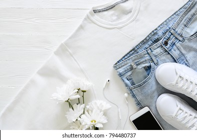 Womens Fashion White Clothing, Shoes, Accessories (white Leather Sneakers, Blue Jeans, Sweatshirt, Headphones, Perfume, Flowers. Fashion Concept. View From Above, Flat Lay. Spring Summer Collection