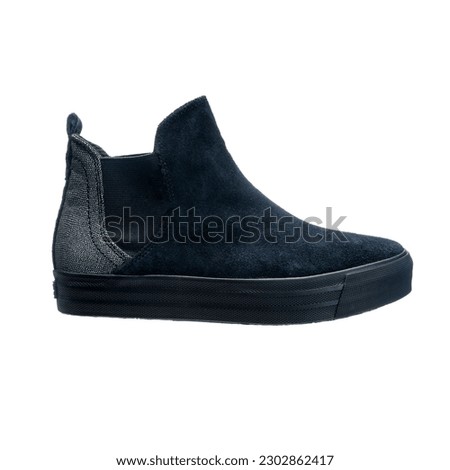 Women's fashionable boots made of suede and polished leather on a flat sole, isolated object on a white background